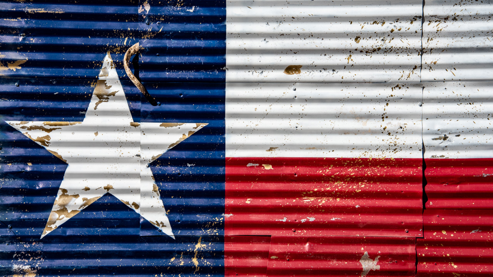 A mural of the Texas flag seen on a corrugated tin wall in Dripping Springs.