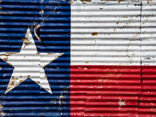 A mural of the Texas flag seen on a corrugated tin wall in Dripping Springs.